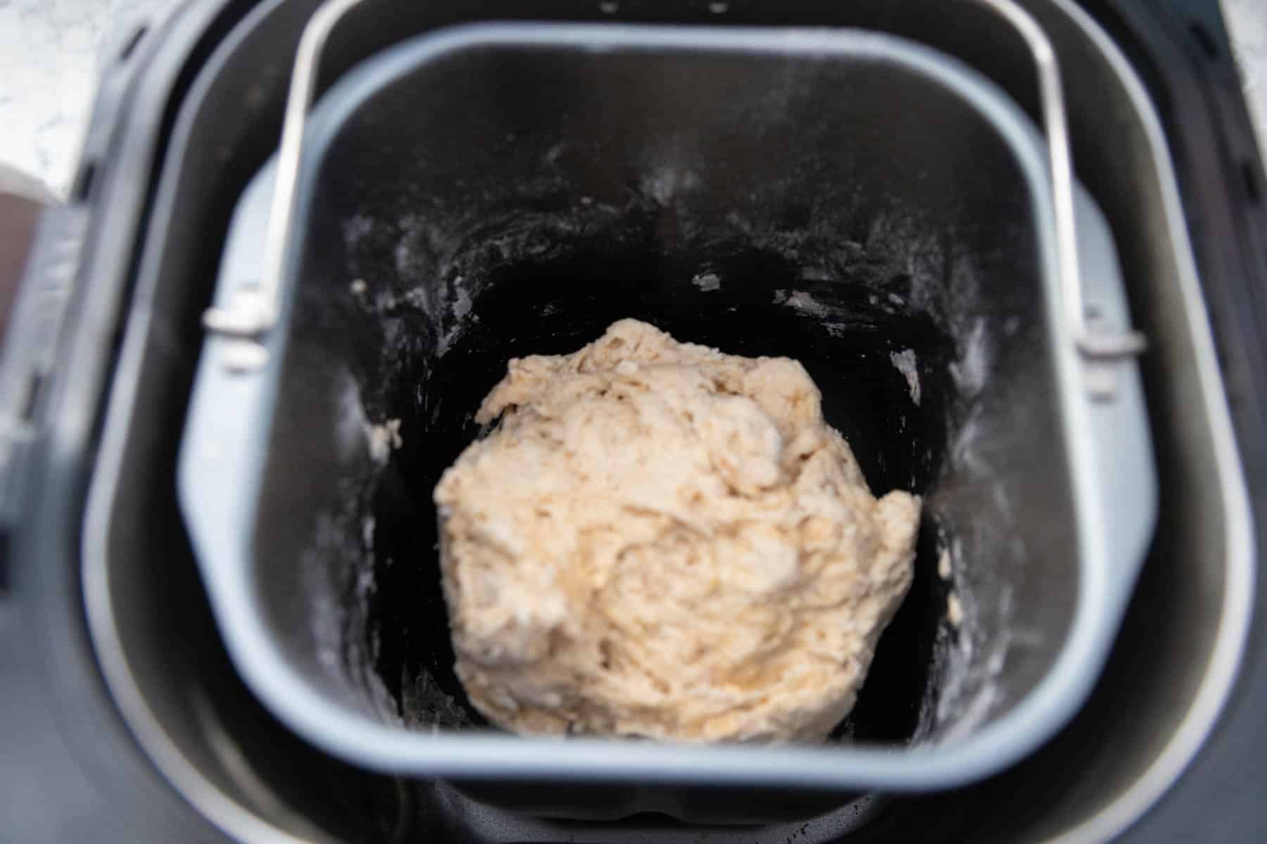 The dough is being kneaded in the bread machine.