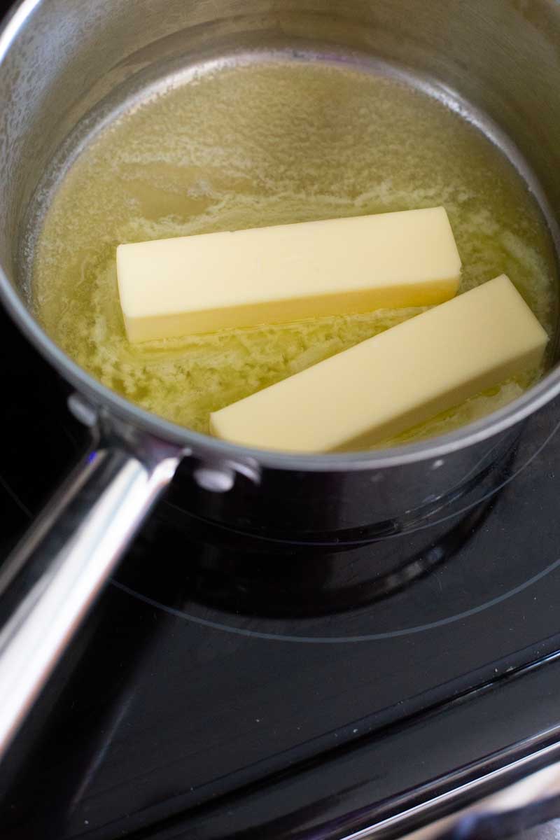 2 sticks of butter are melting in a saucepan.
