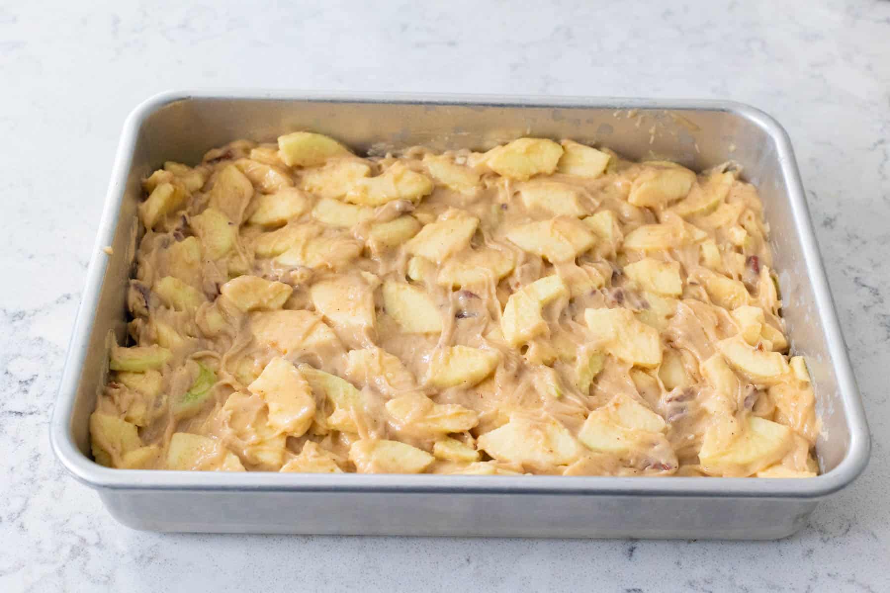 The batter has been spread into a metal 9x13-inch baking dish and is ready for baking.
