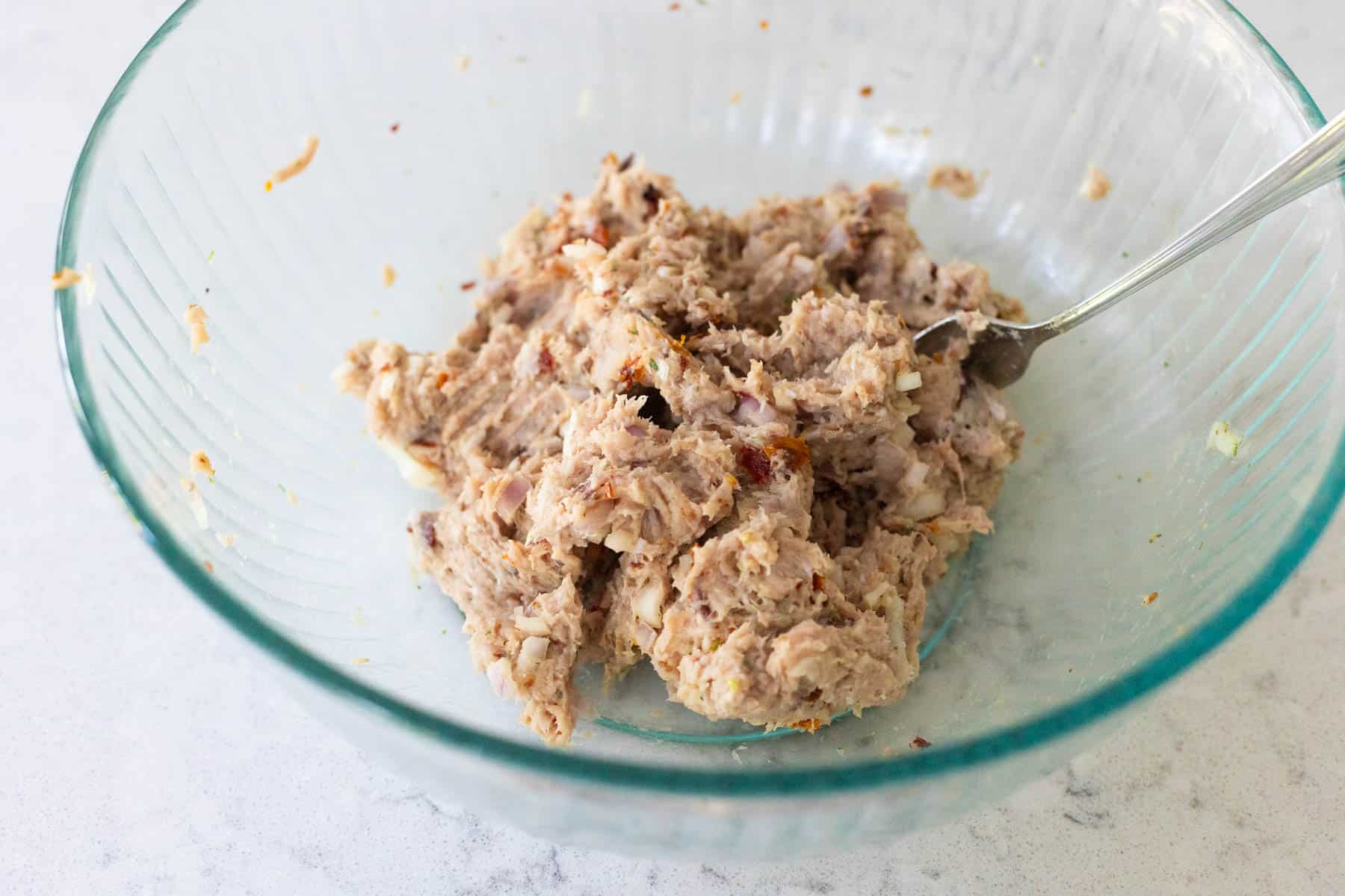 The meat has been combined with the seasonings.