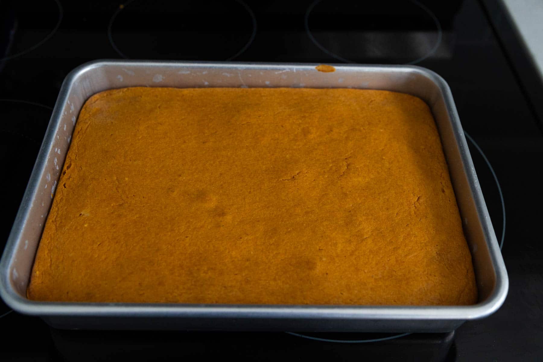 The pan has just come out of the oven so you can see the texture of the finished top. It has a few slight cracks and barely jiggles when it is pulled.