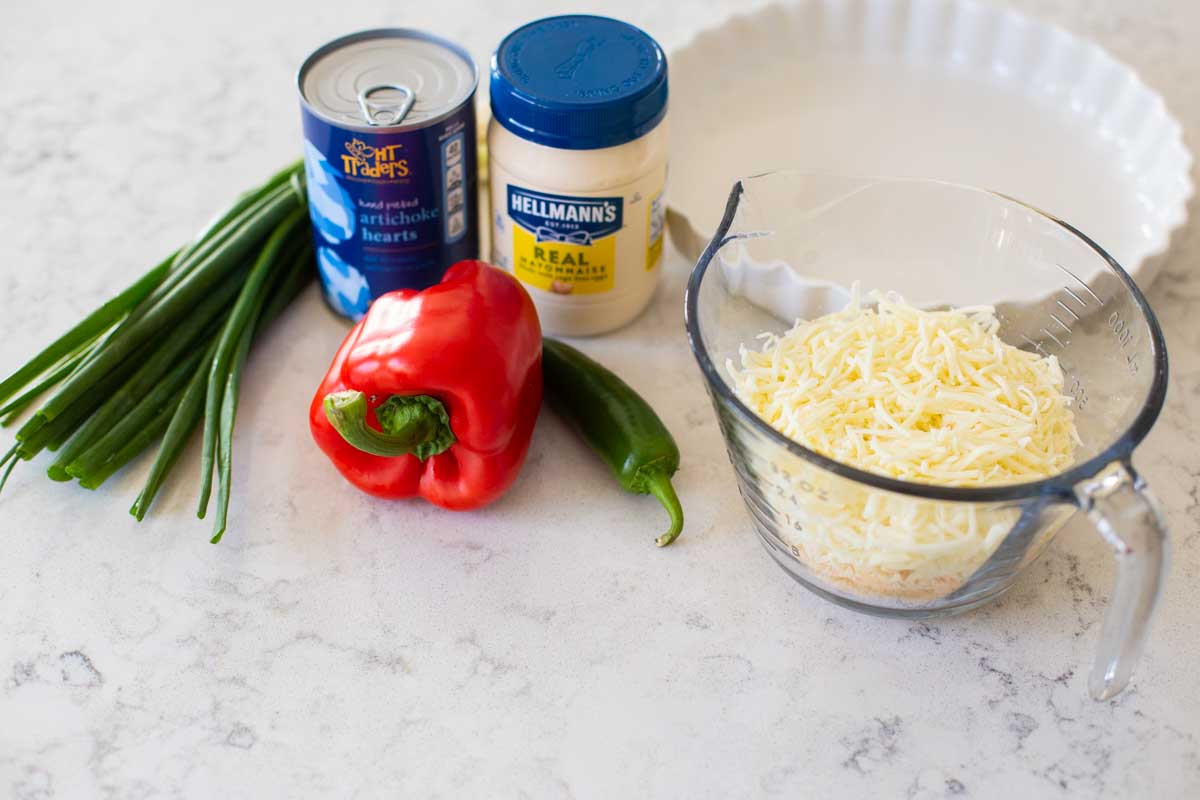 The ingredients to make fresh jalapeño artichoke dip are on the counter.