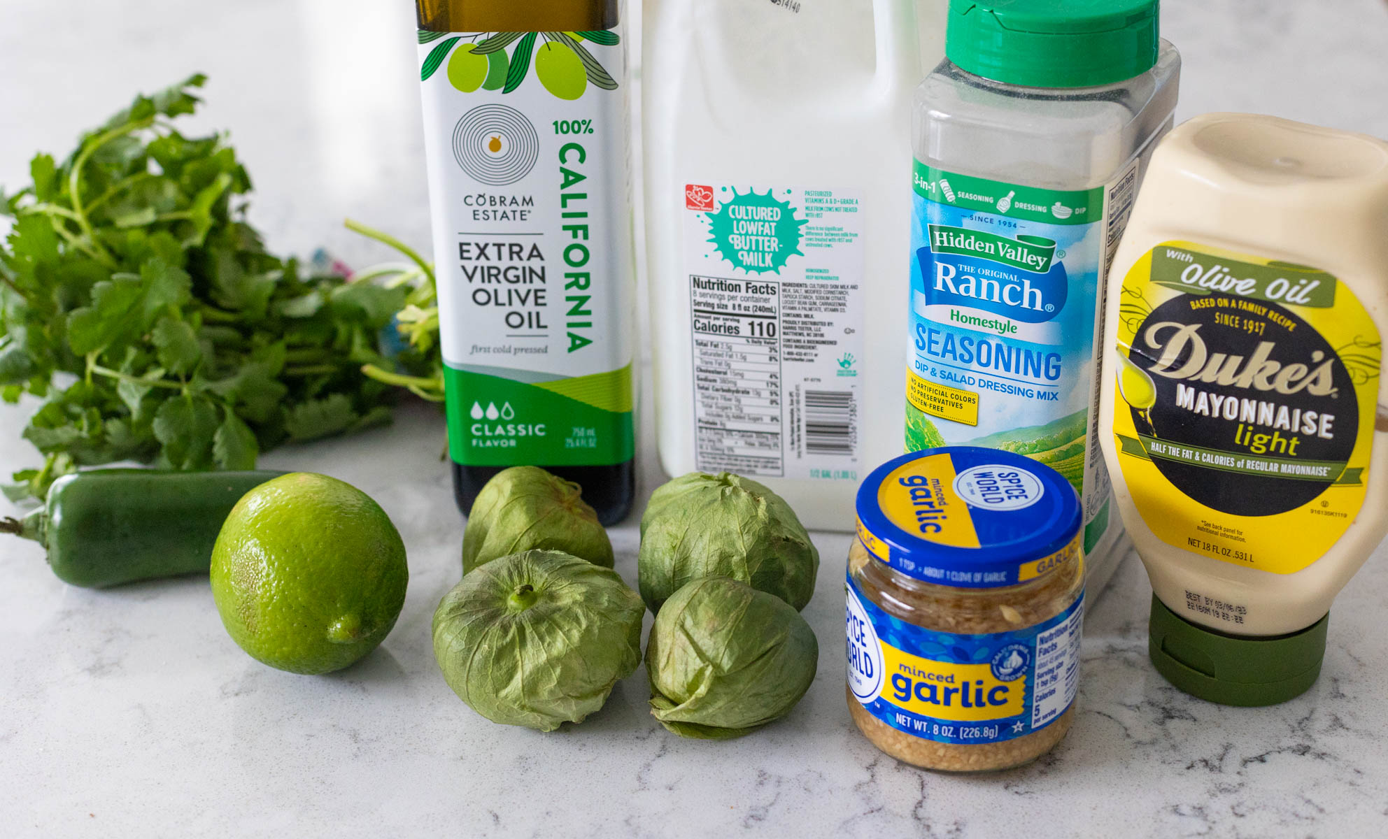 The ingredients to make cilantro lime ranch are on the counter.