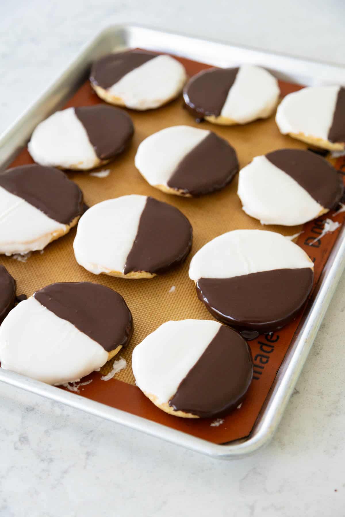 The cookies have been iced with both the black and the white icing.