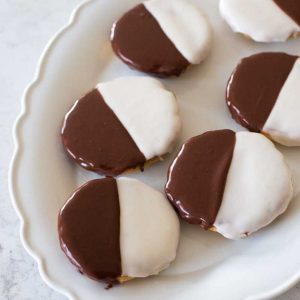 A serving platter filled with black and white cookies.