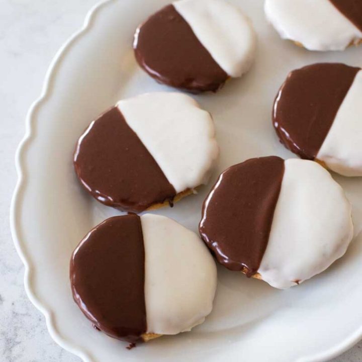 A serving platter filled with black and white cookies.