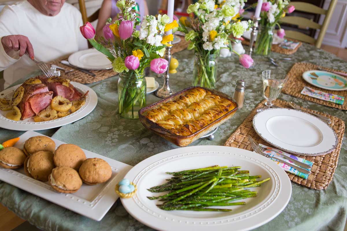 A family Easter dinner has been set at a simple dining table.