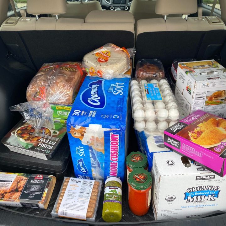 A car trunk is loaded with pantry supplies for an emergency.