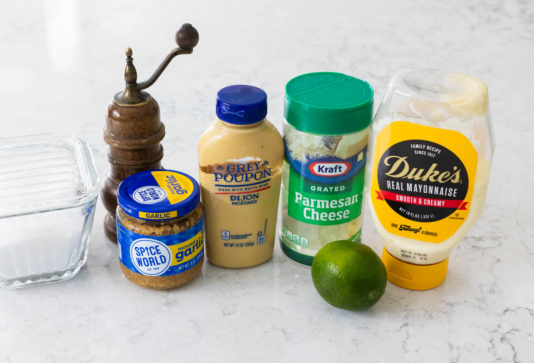 The ingredients to make homemade Caesar salad dressing are on the counter.