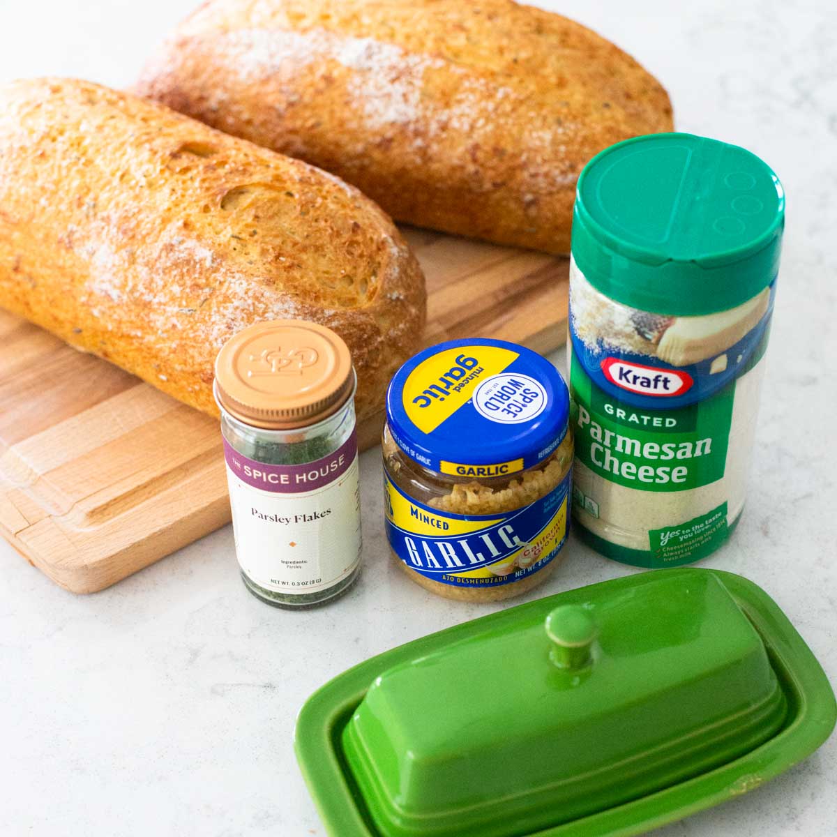 The ingredients for the homemade garlic bread are on the counter.