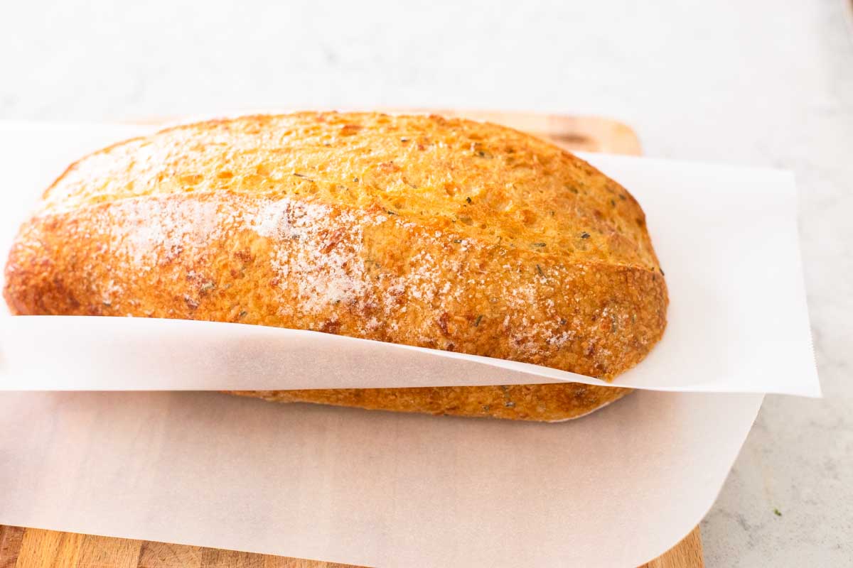 The garlic bread has a layer of parchment paper in between the layers to prevent sticking during freezing.