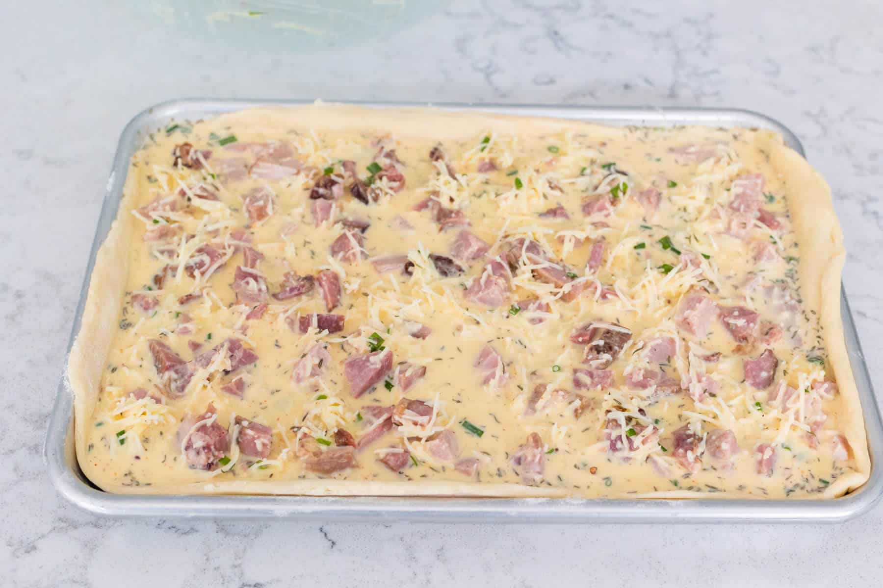 The ham filling has been added to the baking pan.