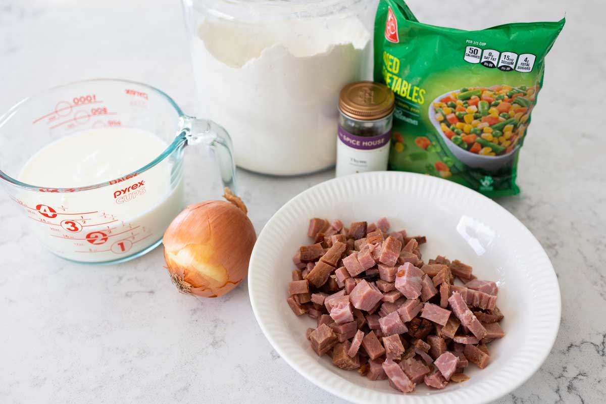 The ingredients to make a homemade ham pot pie are on the counter.