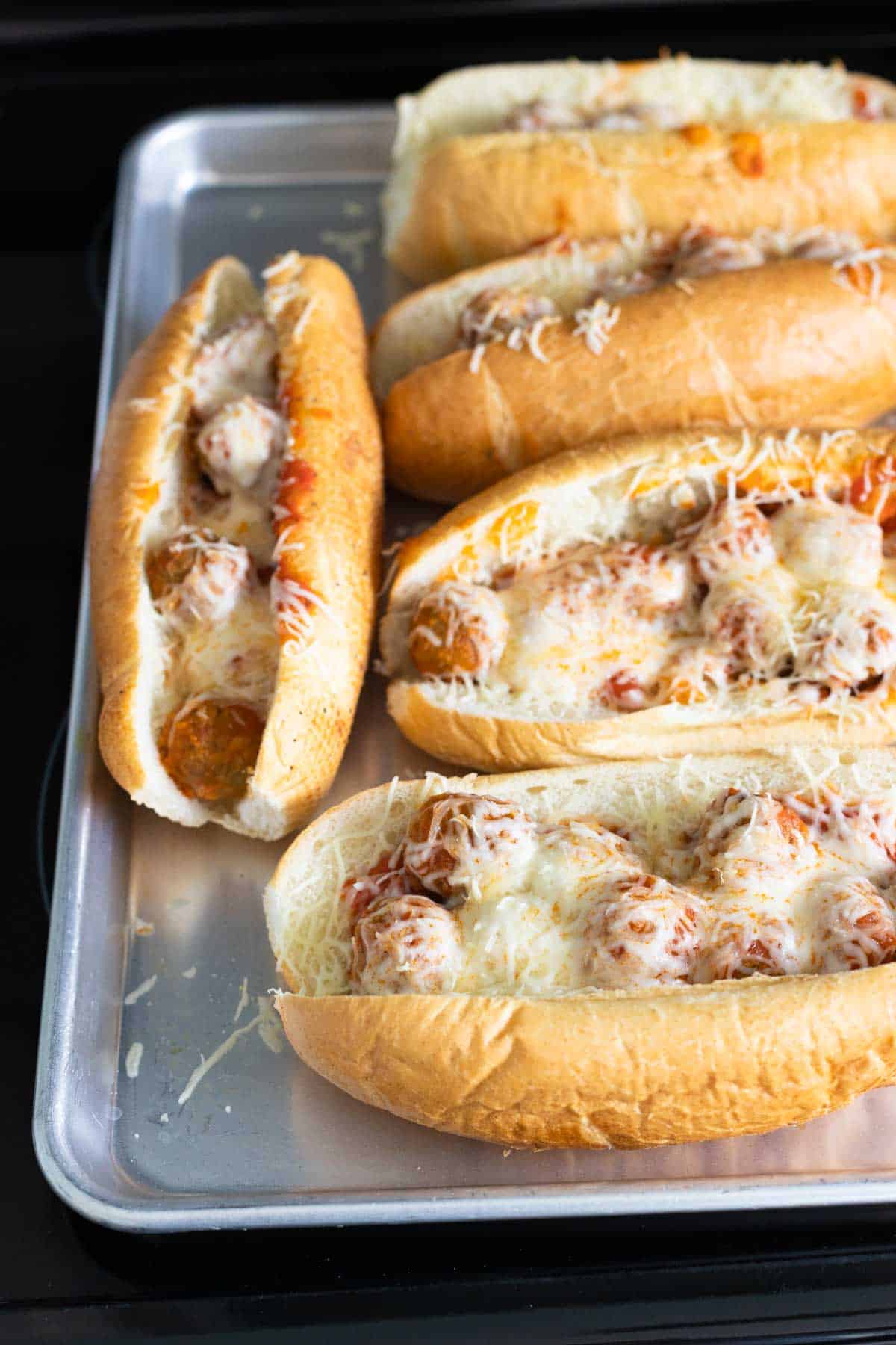 The meatball subs now have melted cheese over the top.