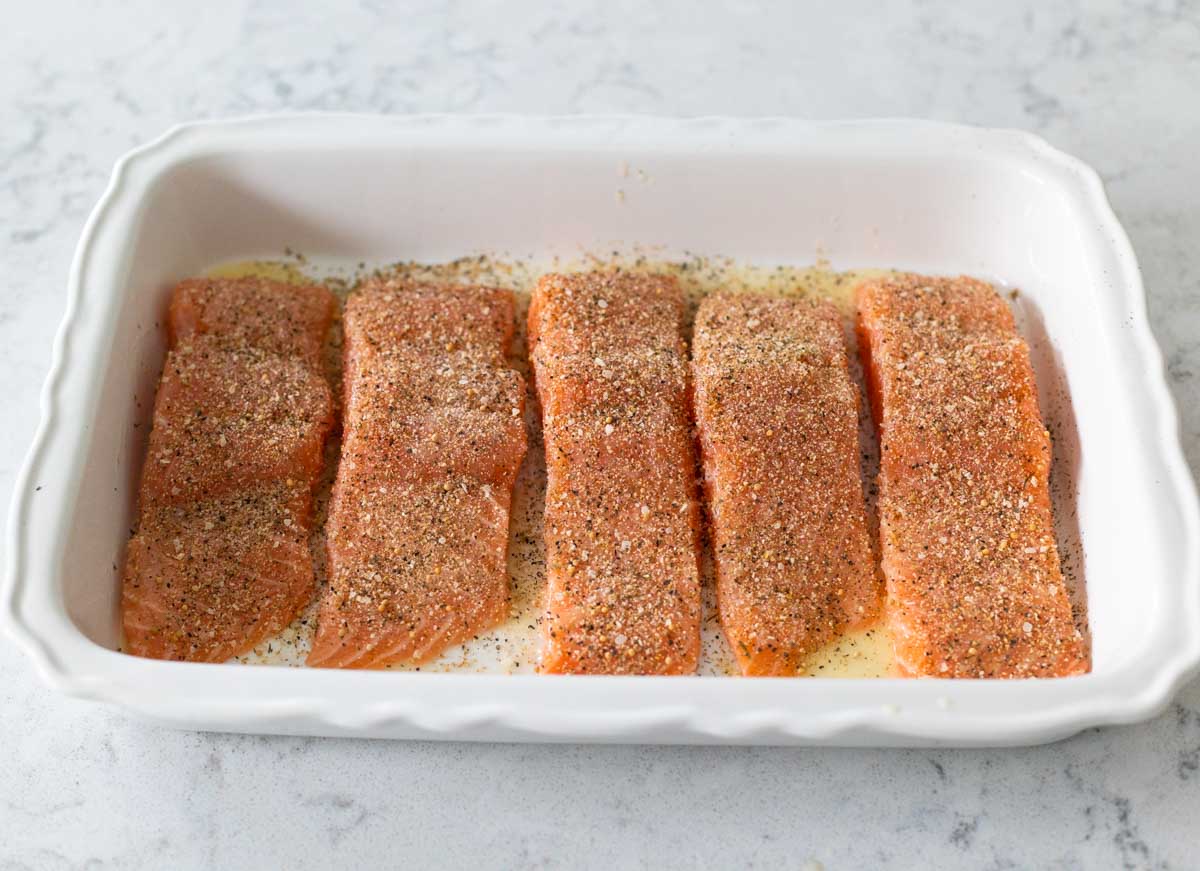 The salmon fillets have been coated in seasoning.