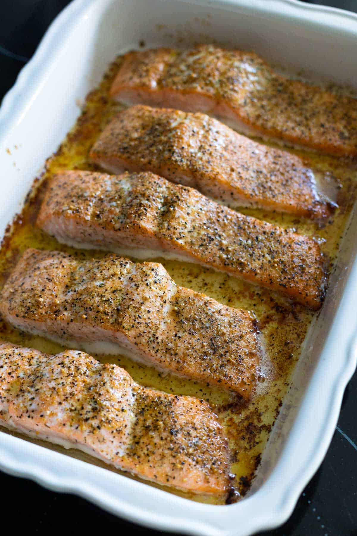 The baking pan of salmon just came out of the oven. The tops are golden and the edges are barely crisped.