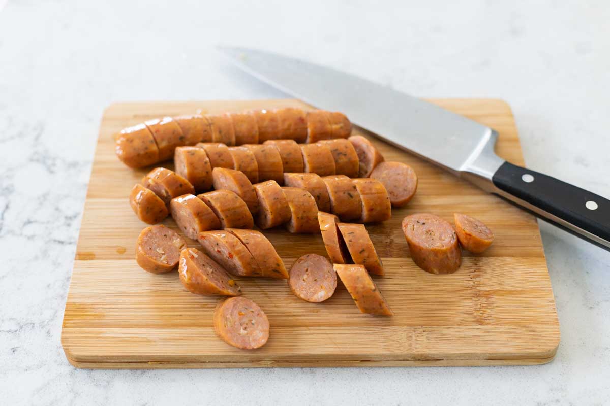 The sausages have been sliced on an angle with a large chef knife.