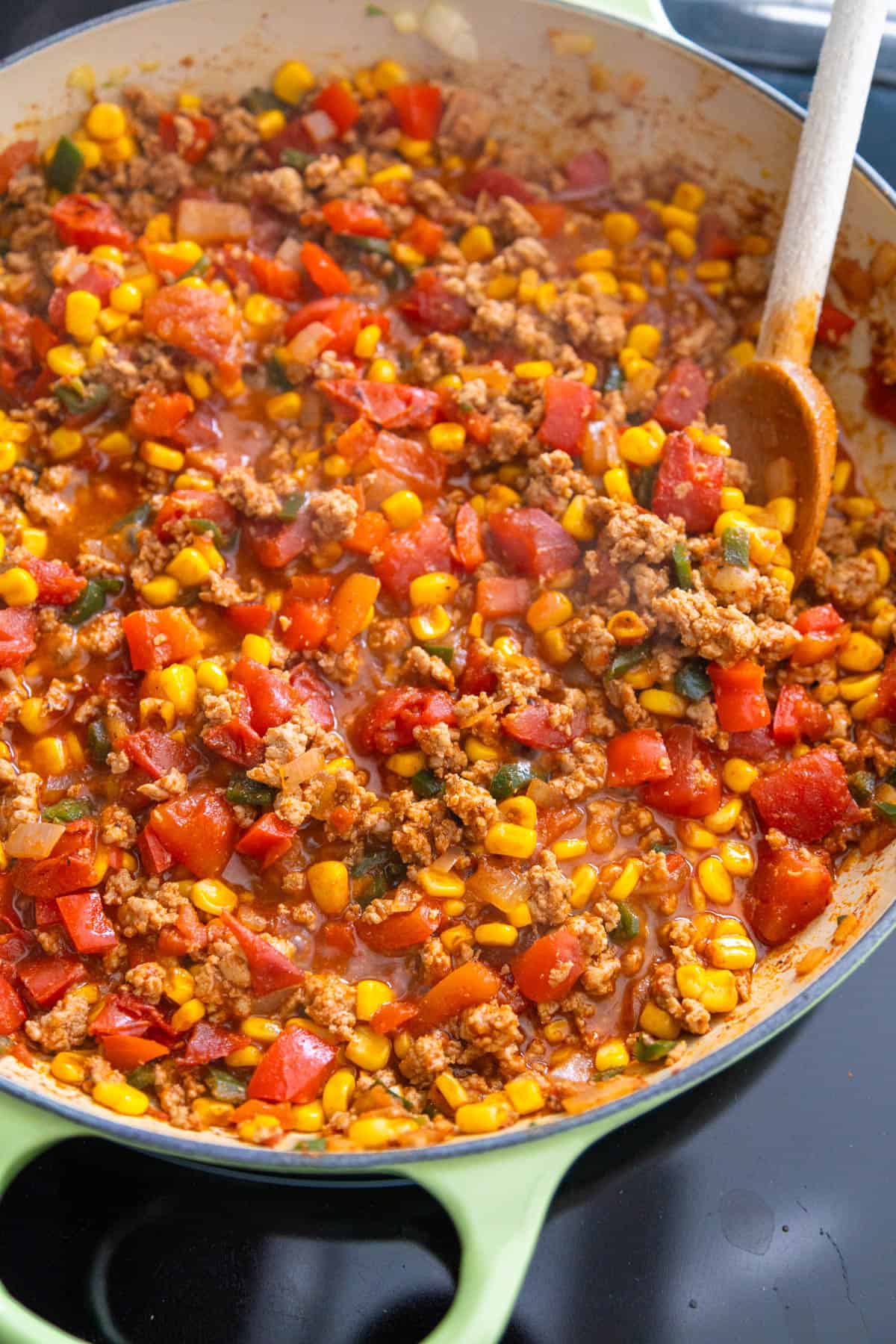 The taco skillet mixture has simmered and thickened on the stovetop.