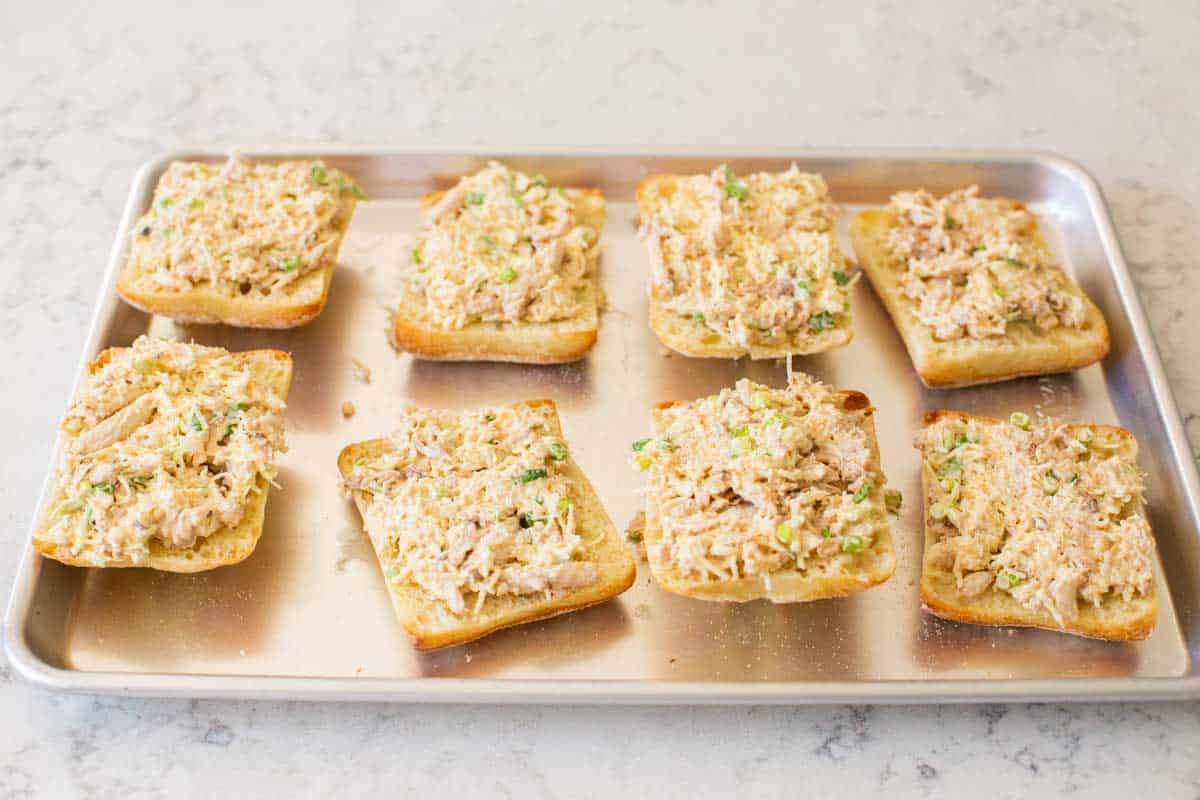 The ciabatta rolls have been topped with the crab filling for baking.