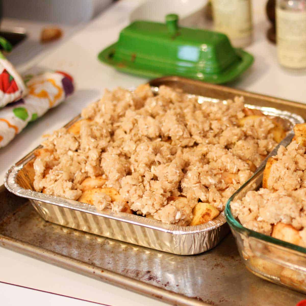 A freezer-friendly metal pan holds an 8x8-inch apple crisp with crumble topping.