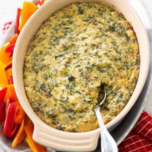 A baking dish filled with warm artichoke dip.