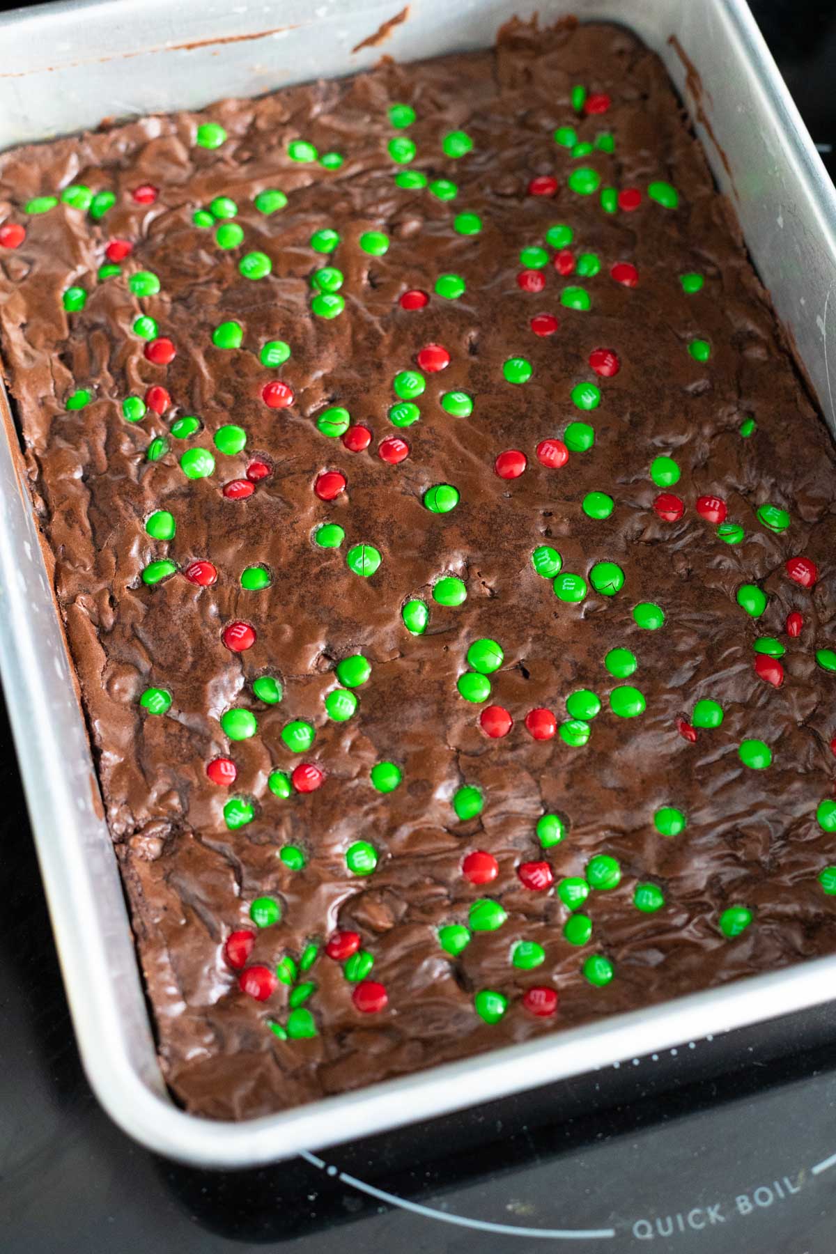 Red and green candies have been pressed into the top of the brownies before baking.