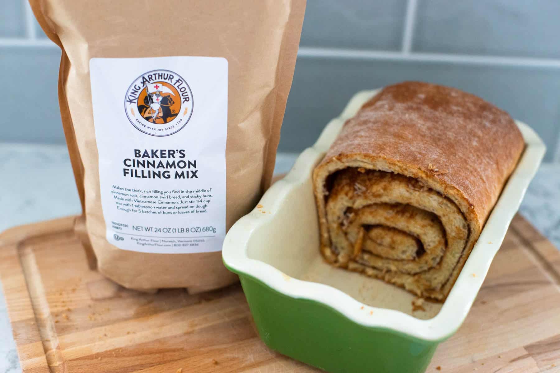 A packet of King Arthur cinnamon filling sits next to the loaf of cinnamon swirl bread.