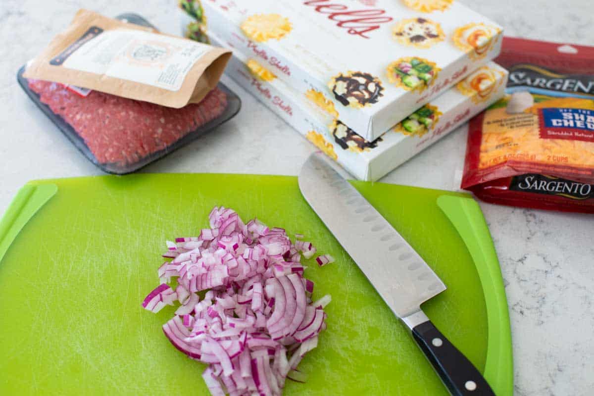 The ingredients to make crispy taco bites appetizer are on the counter.