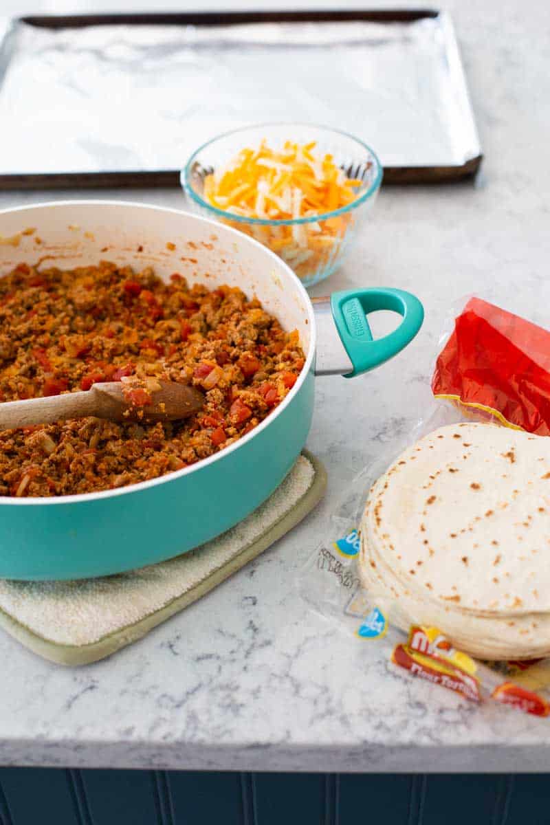 The ingredients to make the taquitos are assembled on the counter.