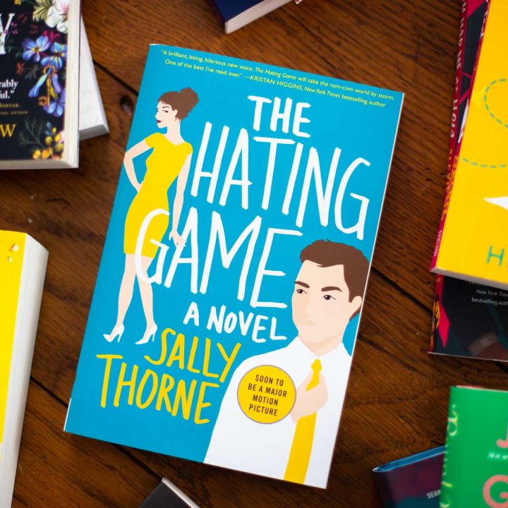 A copy of The Hating Game by Sally Thorne sits on a table.