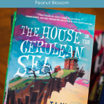 A copy of The house in the Cerulean Sea by TJ Klune with the caption: Book Club Discussion Guide.