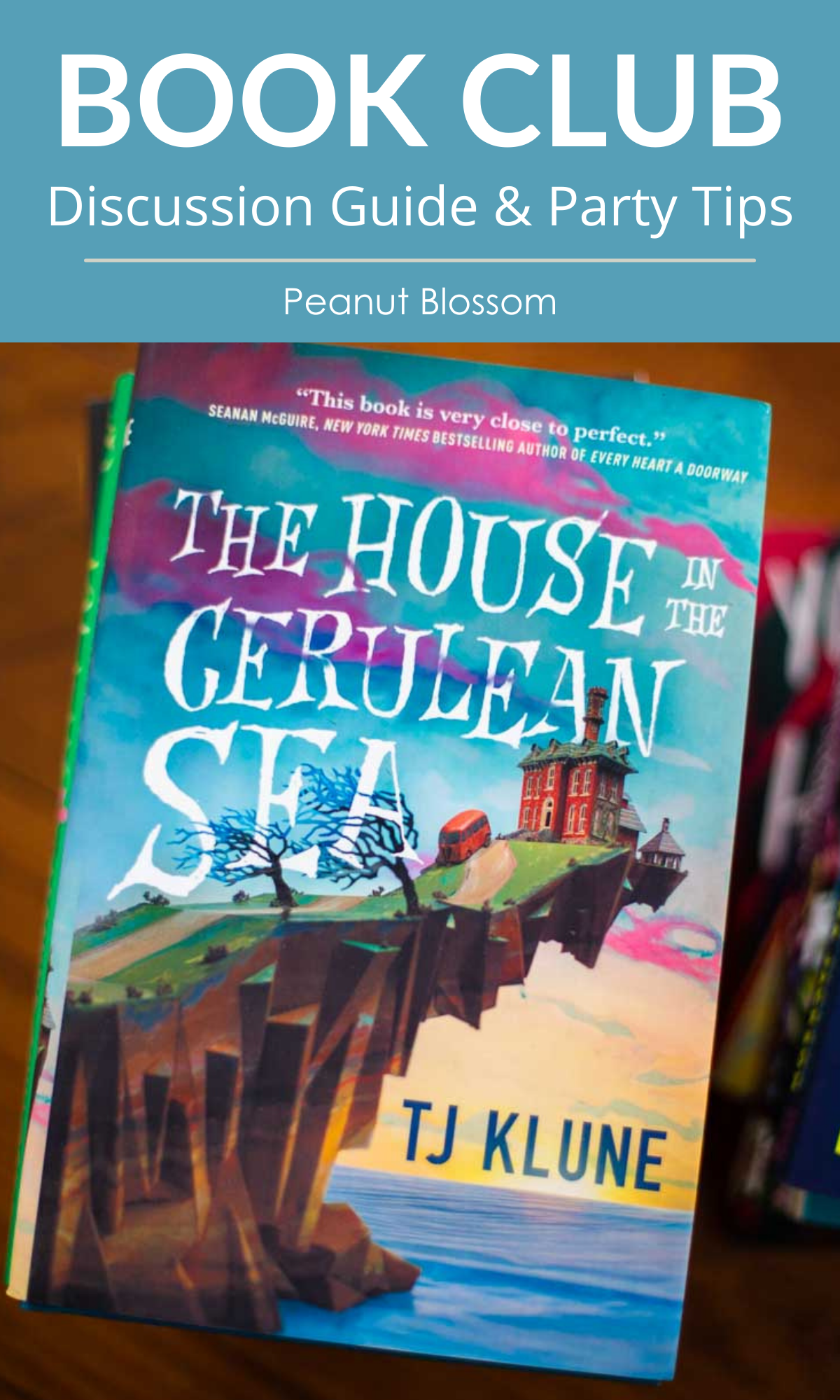 A copy of The house in the Cerulean Sea by TJ Klune with the caption: Book Club Discussion Guide.