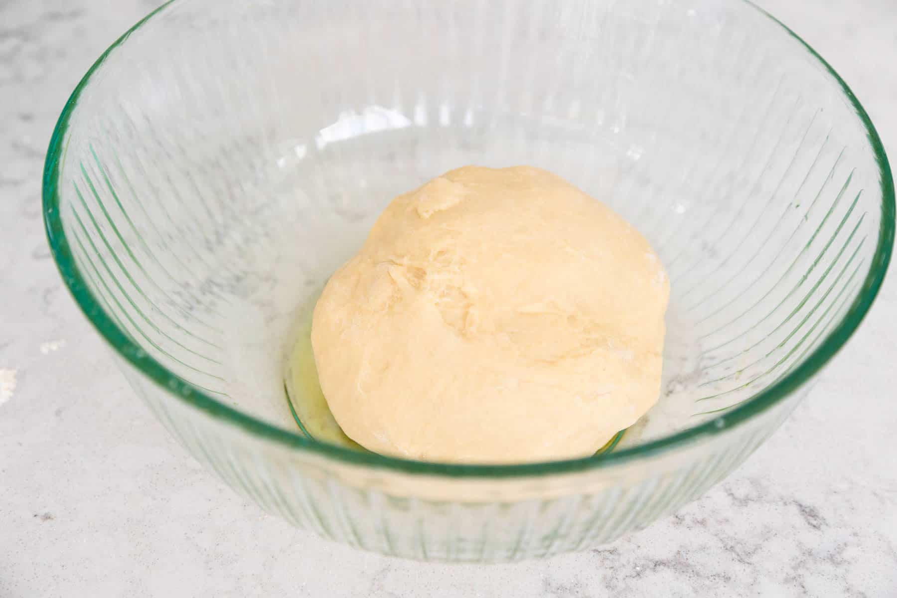 The dough ball is in a bowl ready for the first rise.