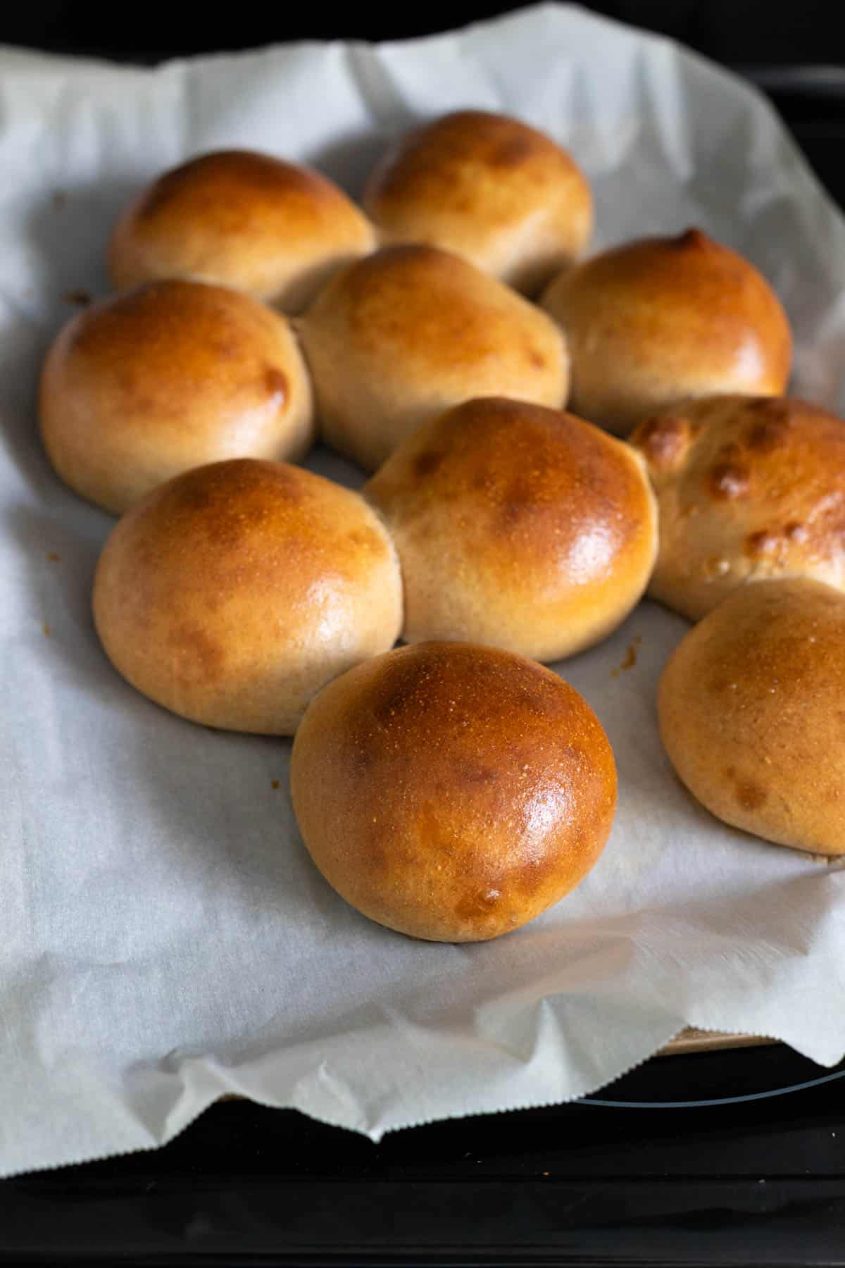 The hamburger buns are fresh from the oven and a deep golden brown color.