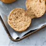 A hamburger bun has been cut open to show the texture inside.