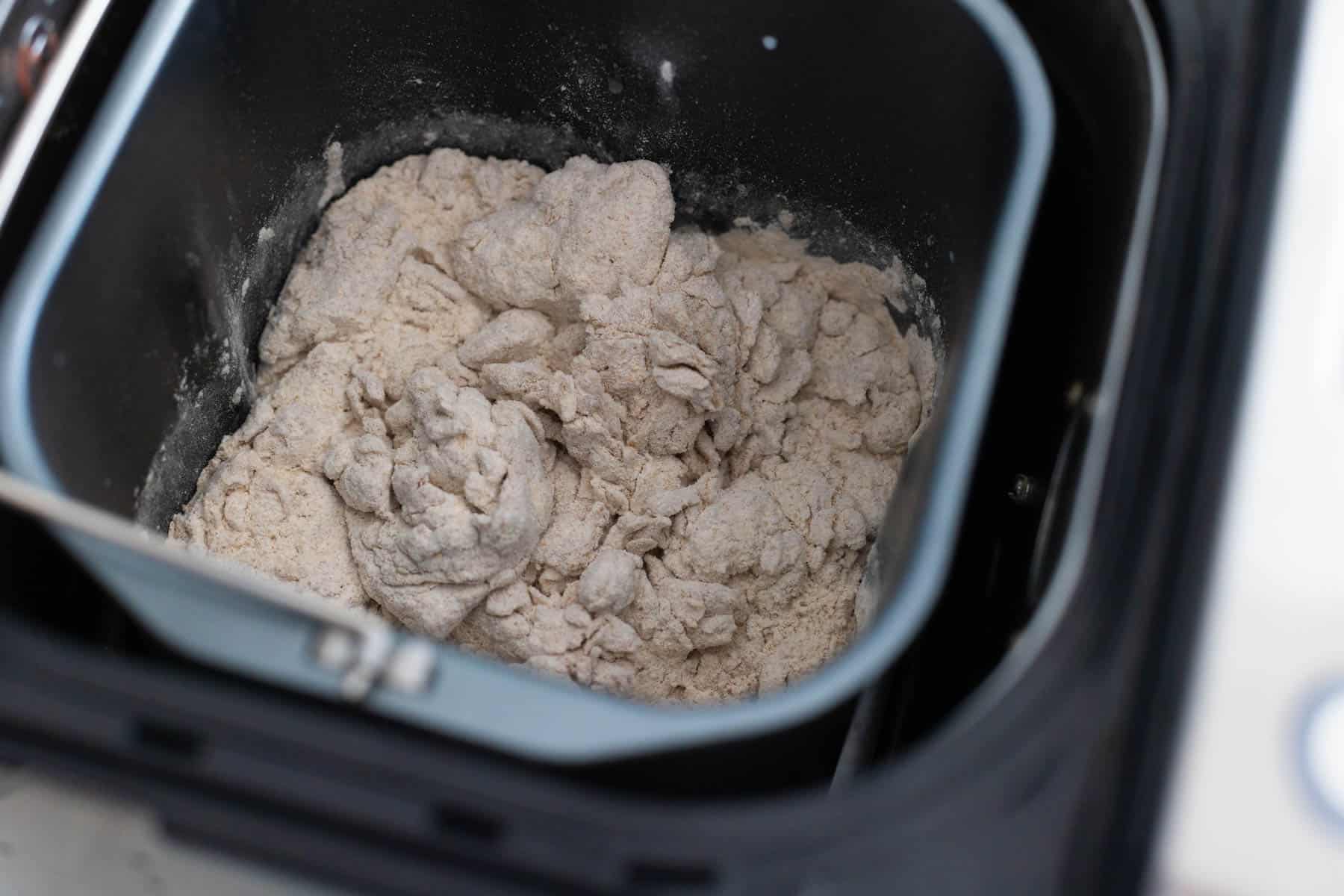 The whole wheat dough is mixing in the bread pan.