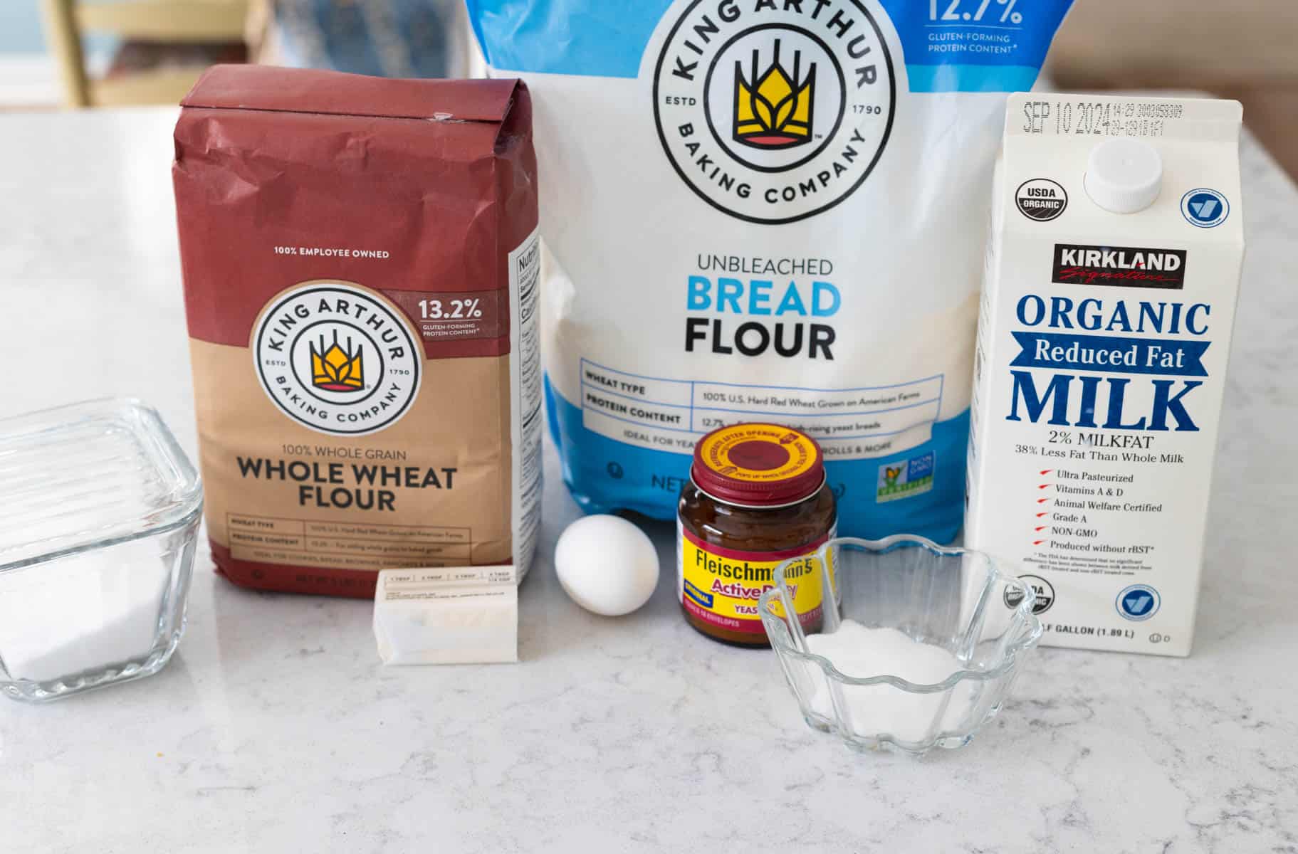 The ingredients to make whole wheat hamburger buns are on the counter.