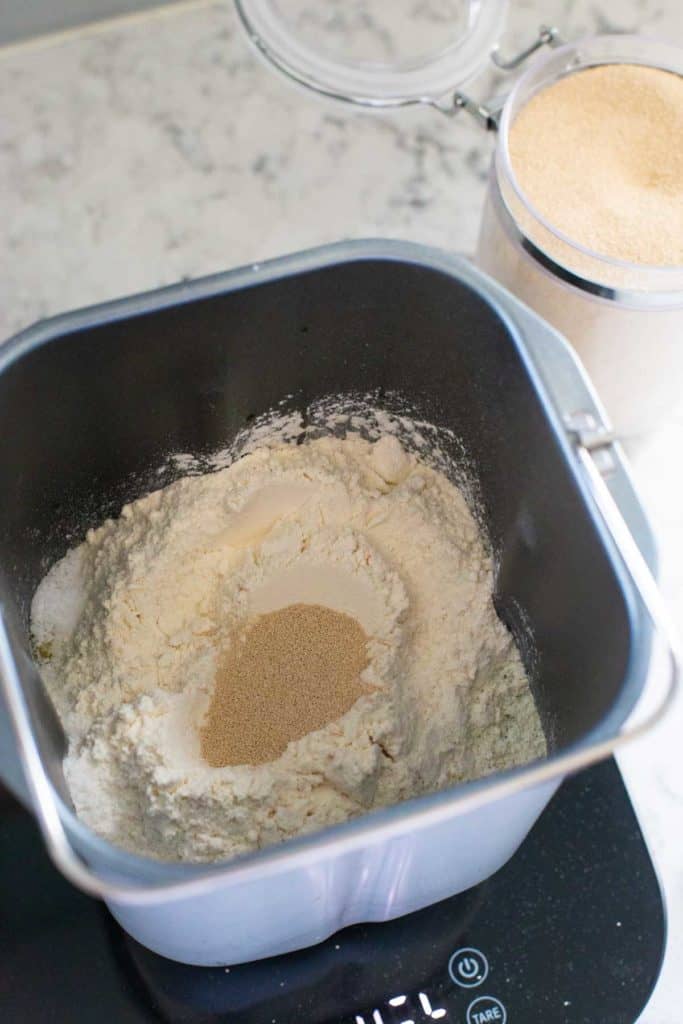 A visual for how to load the bread machine pan with flour and yeast. There's a well in the center of the flour for the yeast.