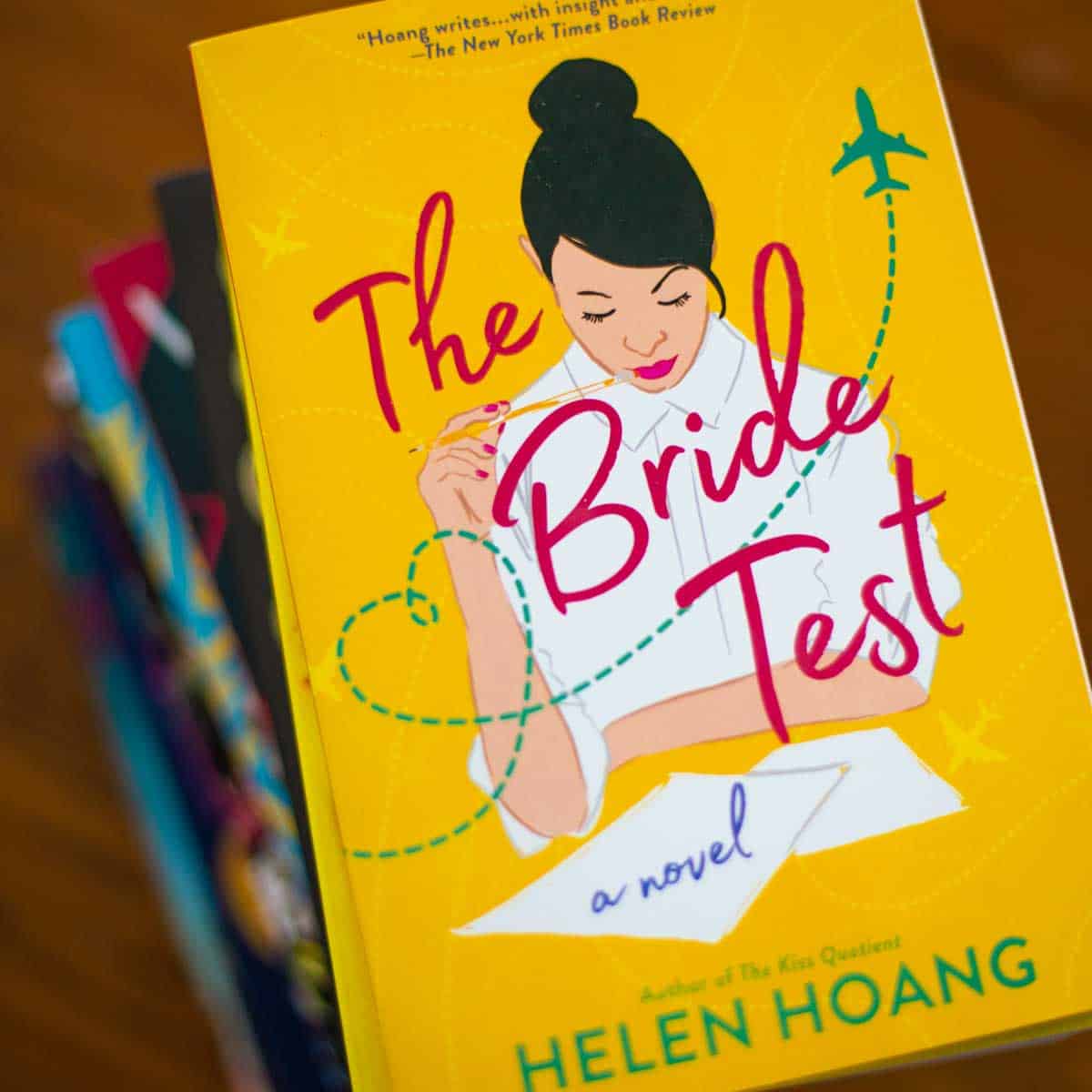 The copy of The Bride Test by Helen Hoang sits on a pile of books.
