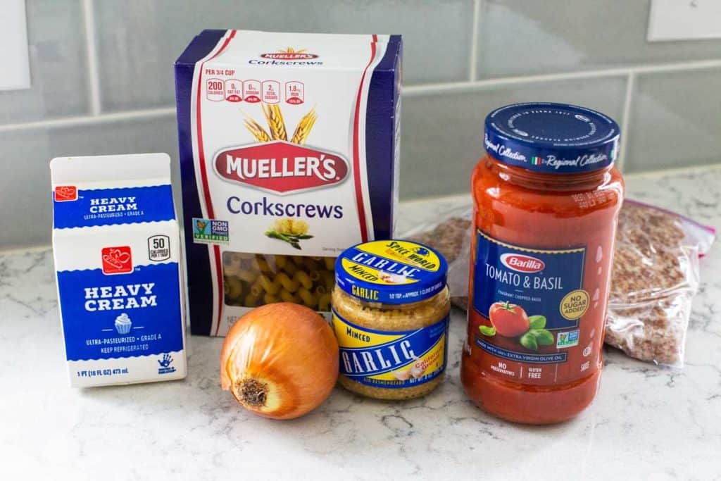 The ingredients for pasta rosa sit on a kitchen counter.