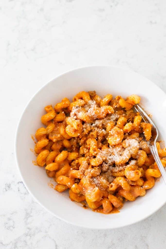 The finished pasta rosa is in a white bowl with a fork.