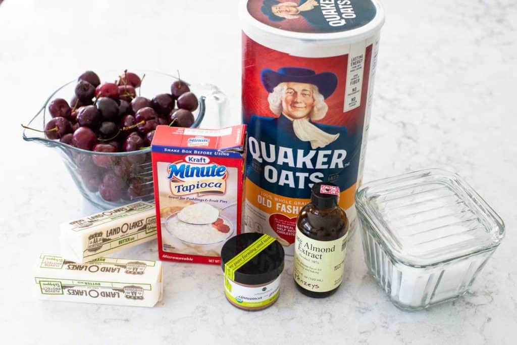 The ingredients for the cherry crisp are shown on a kitchen counter.