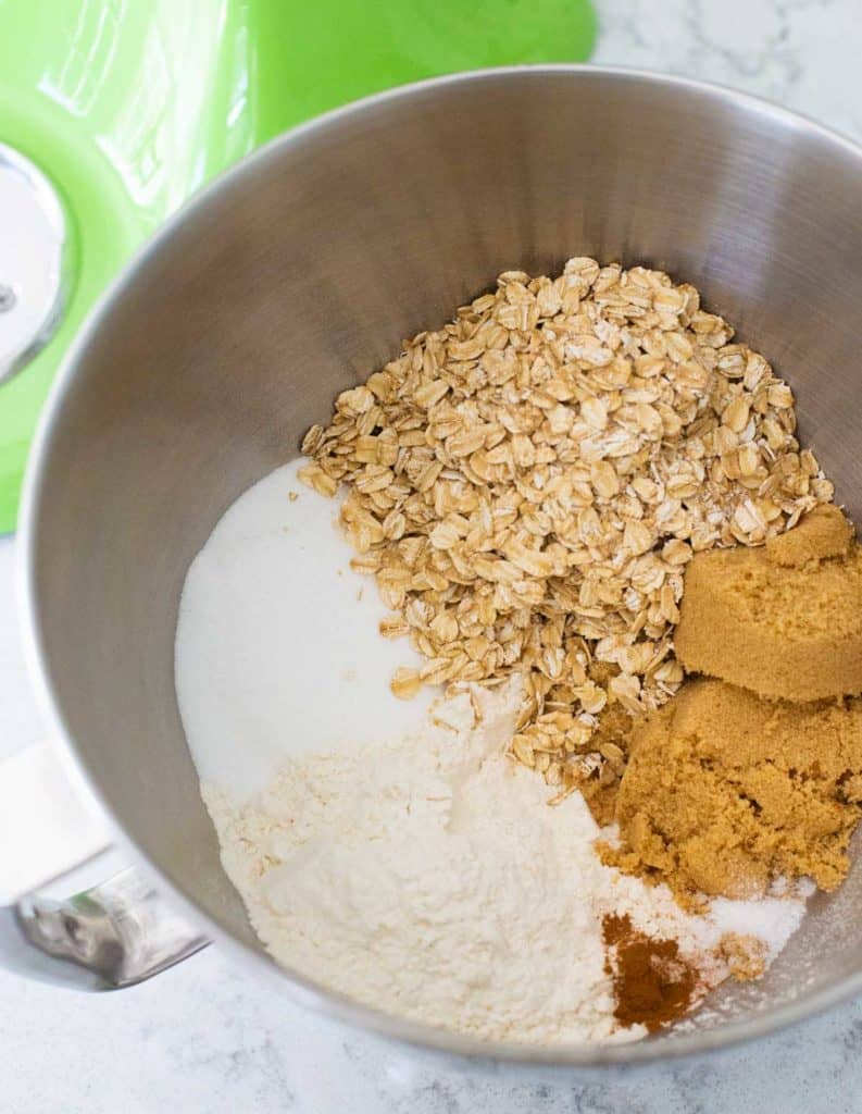 The ingredients for the cherry crisp topping are in the bowl of a stand mixer.