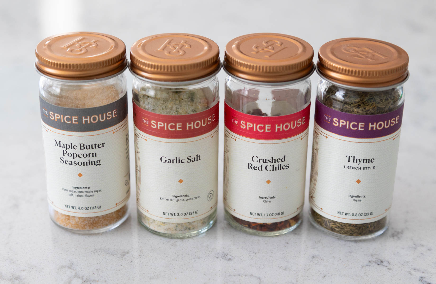 A row of spice jars are lined up so you can see the best seasonings for carrots.