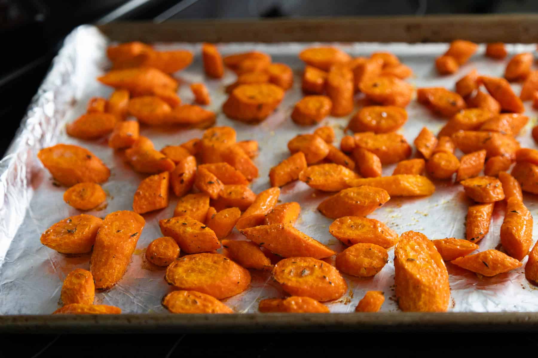 The carrots have just come out of the oven, you can see the browned edges and seasonings on top.