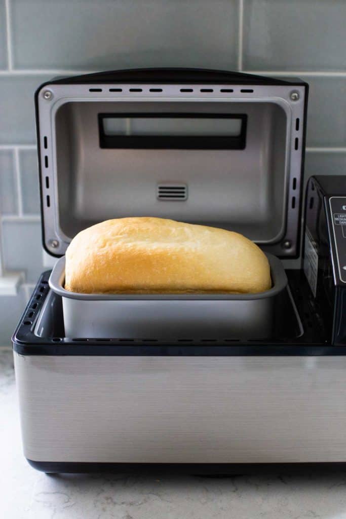 A finished loaf of bread inside the bread machine that baked it.