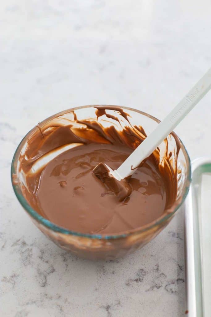 A bowl of melted chocolate candy for filling the frog molds.