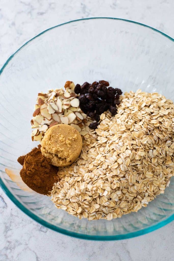 The ingredients for granola are in a large mixing bowl ready to be stirred.