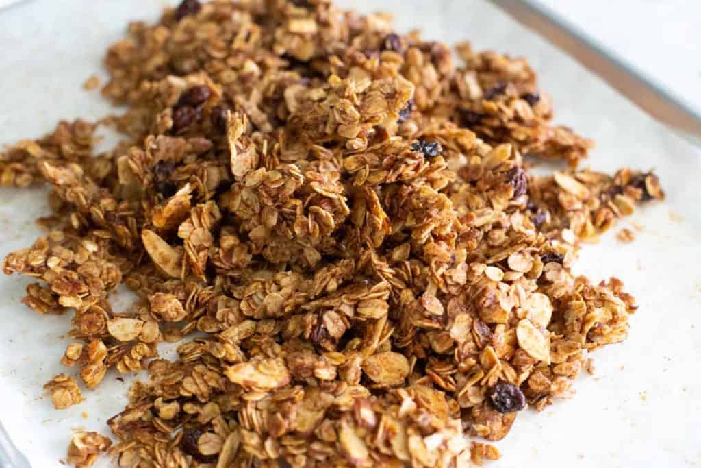 The baked granola is crumbled after cooling.