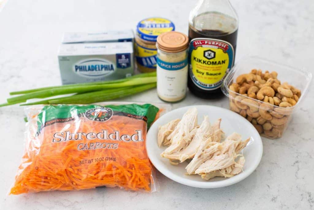 Ingredients for the Asian chicken layered dip are on a counter.